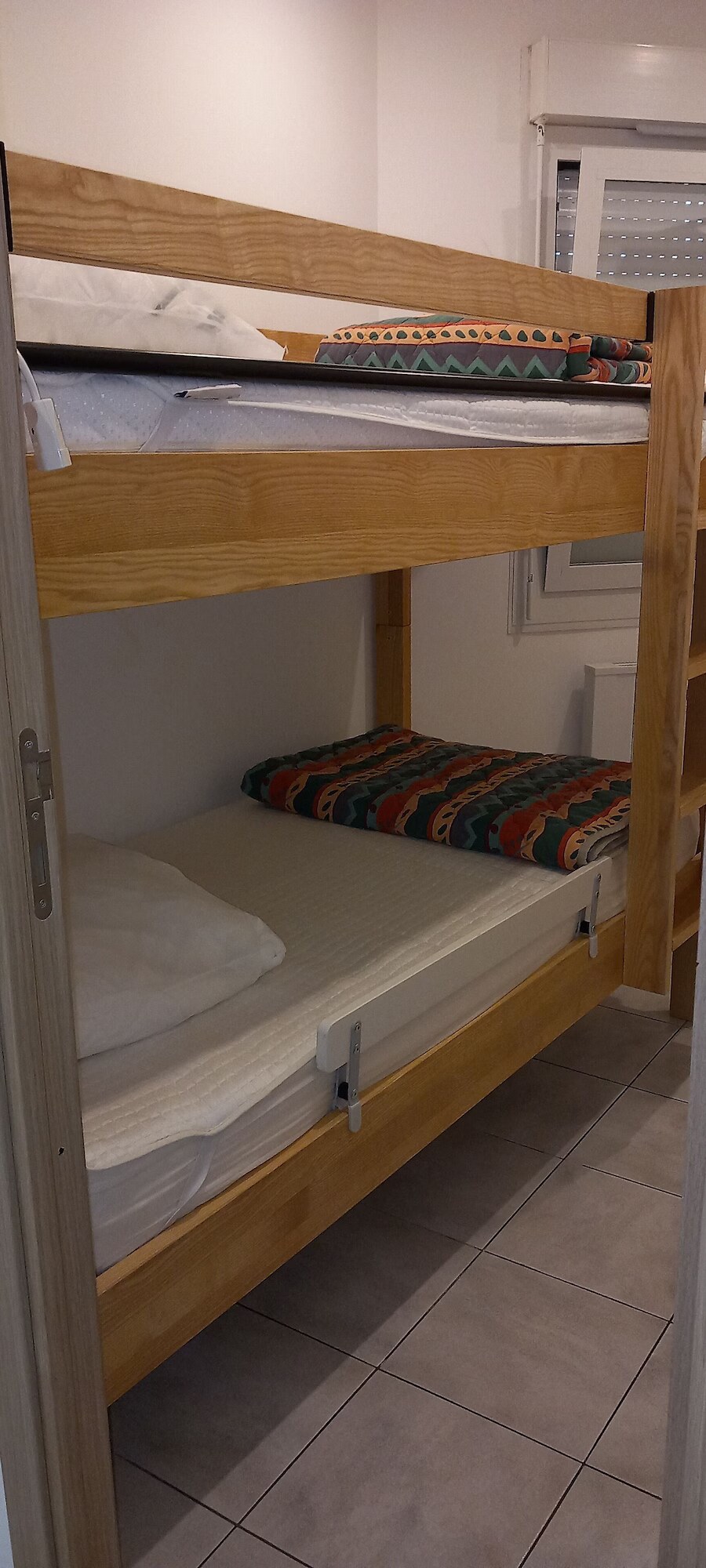 Solid wood bunk beds with safety rail in the children's cabin room