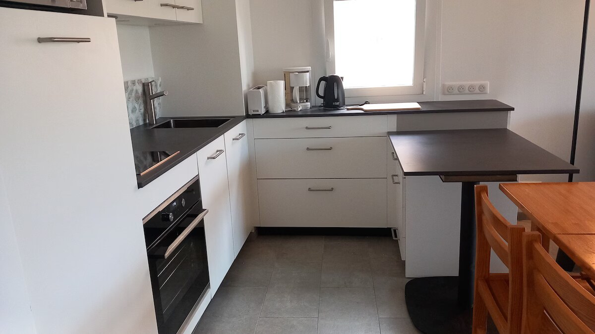 Worktop, induction hob and breakfast bar of the 2024 fitted kitchen