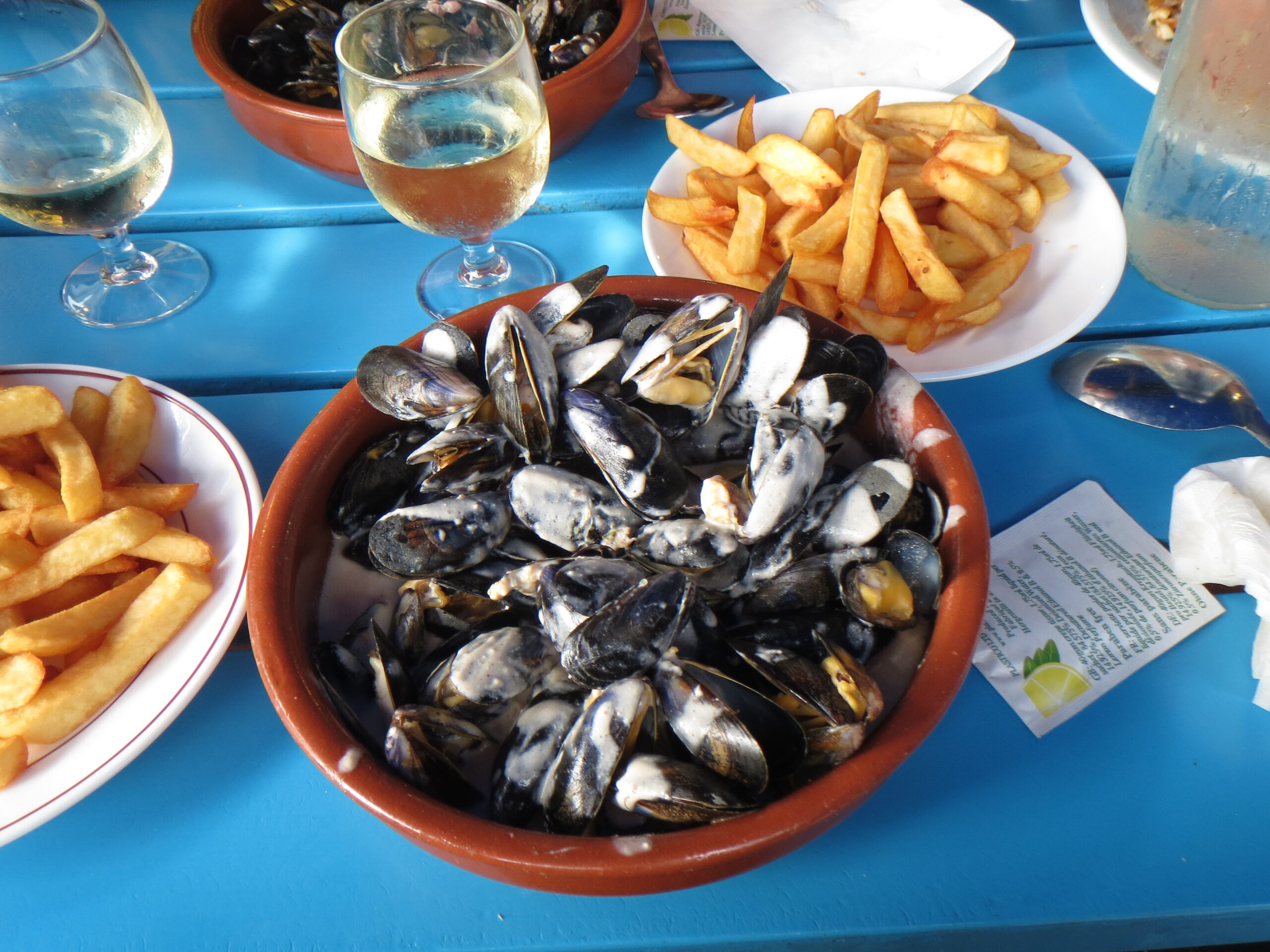 Moules-frites and chilled white wine at a beach restaurant in Moliets
